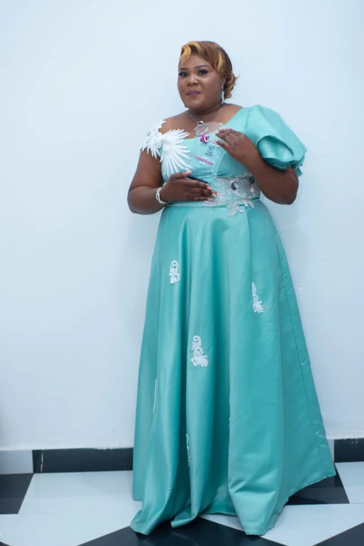 CEO holding an event-industry award in a turquoise gown